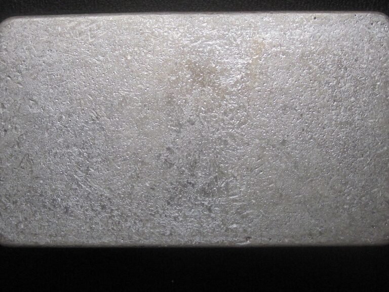 Close-up of a cast silver bar with dips, ripples, and satin frost finish from Scottsdale Silver